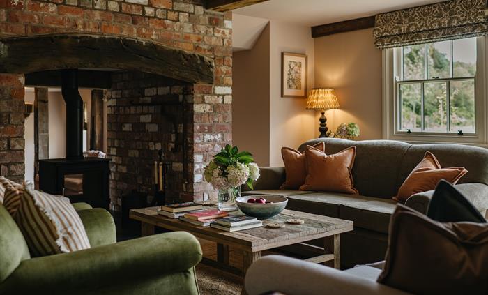 A lounge with a sofas and a wood burning fire